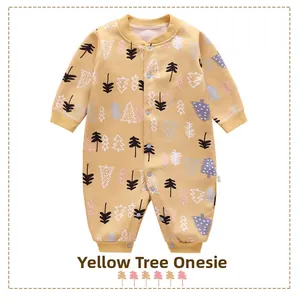 Detail of warm yellow baby romper with colorful tree patterns and button closures