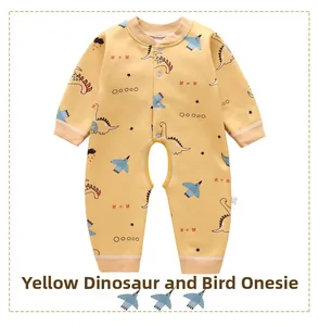 Close-up of yellow baby romper featuring cartoon dinosaur prints and button-down front