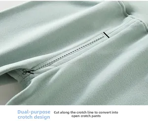 Détail du pantalon thermique bébé vert menthe montrant l'entrejambe adaptable découpable