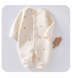 Detailed view of quilted thermal baby romper with pink patterns and snap button front