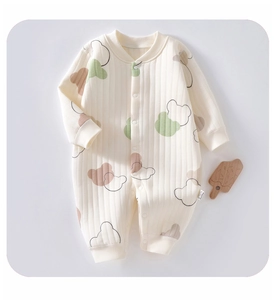 Detailed view of baby romper featuring soft ribbed cotton fabric and cute cartoon bear prints
