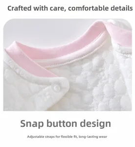Close-up of quilted baby thermal top showing pink ribbed collar and snap button closure