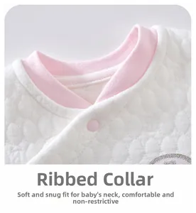 Close-up of baby warm quilted fabric with pink ribbed neckline and soft snap button