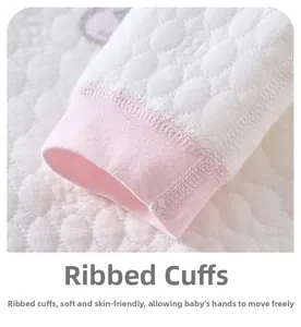 Close-up of quilted thermal baby sleeve with pink ribbed cuffs and soft stitching detail