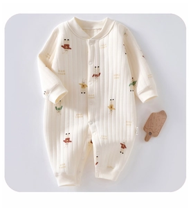 Close-up of baby romper showing cream ribbed fabric and cute bunny cartoon patterns