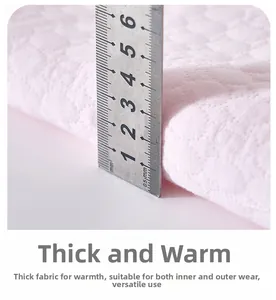Detailed macro view showing the quilted thickness and diamond pattern of baby thermal fabric