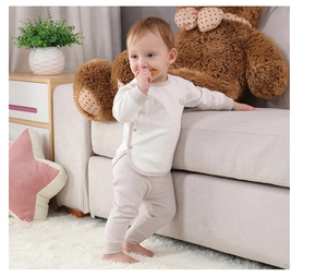 Cozy cotton baby pajama set featuring light top and high-waisted pants for infant comfort