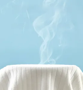 Breathable white ribbed cotton baby onesie showing high airflow through the fabric