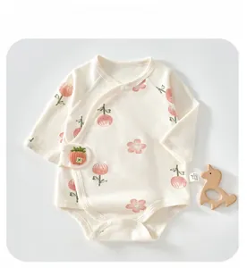 Close-up of baby long sleeve cotton bodysuit featuring strawberry buckle and floral print