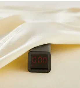 Close-up of cotton baby fabric being tested for zero formaldehyde with digital meter