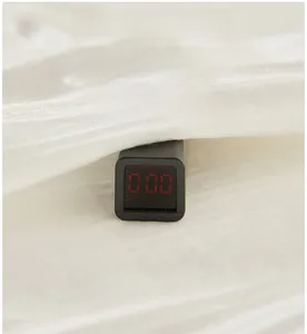 Close-up of baby romper fabric testing zero for fluorescence on a digital meter