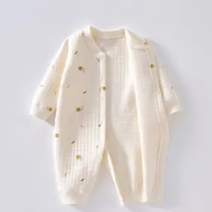Quilted cotton long-sleeve baby romper in cream color with snail and leaf print pattern