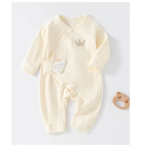 Detail of beige ribbed cotton baby romper with crown embroidery and decorative side wings
