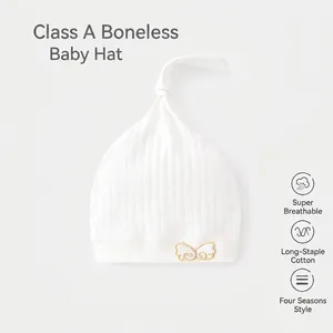White soft organic cotton baby beanie with knot top and bow detail for newborns
