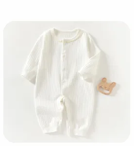 Detail of baby romper with ribbed texture, cute rabbit embroidery, and front buttons