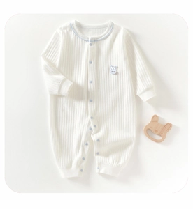 Detail of baby cotton ribbed romper with blue trim and cute rabbit patch on chest