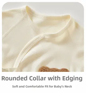 Detail of soft cotton baby bodysuit featuring bound V-neck and cute bear embroidery