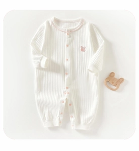 Detail of baby cotton romper with pink rabbit embroidery and rib knit texture
