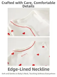 Détail d'un body pour nouveau-né en coton avec cœurs rouges et encolure à bords festonnés