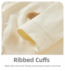Macro shot of ribbed cuffs and cute bear embroidery on soft cotton newborn bodysuit