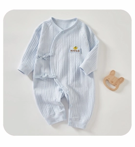 Detail of light blue cotton baby romper with rib knit texture and embroidery