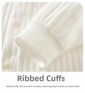 Detailed close-up of soft ribbed cotton baby romper cuffs with secure round snaps