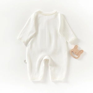 White ribbed cotton long sleeve romper for newborn babies with wooden toy rattle