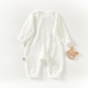 Newborn long sleeve white ribbed cotton romper with wooden bunny teether accessory