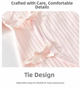 Close-up of pink cotton newborn bodysuit featuring adjustable side-tie bow closures