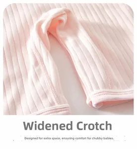 Close-up of baby pink ribbed trousers featuring a widened crotch design for diaper comfort