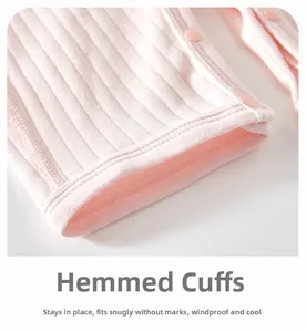 Close-up of pink ribbed cotton baby bodysuit with fine binding and snap buttons