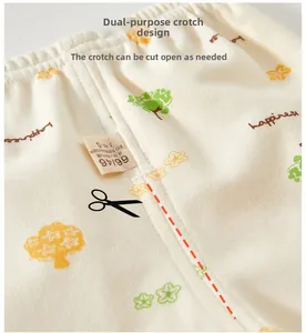 Detail of baby cotton pants featuring tree prints and dual-purpose crotch design