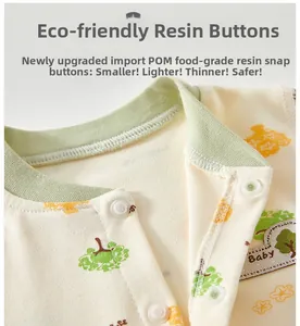 Close-up of baby cotton shirt with food-grade resin buttons and green ribbed neckline