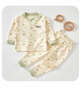 Close-up of soft cotton baby pajama set with cloud prints and button-front top