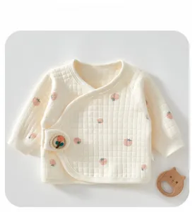 Detail of newborn cotton kimono top with delicate fruit prints and floral embroidery