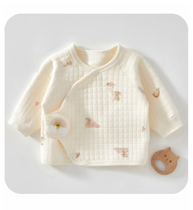 Close-up of quilted cotton baby kimono top with rainbow patch and rabbit pattern