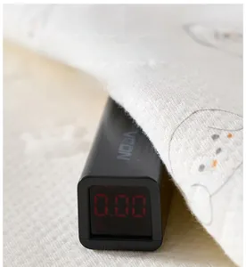Detail of VSON handheld fluorescence detector testing infant fabric with LED screen