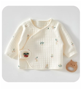 Detail of baby quilted cotton kimono top with floral print and cherry embroidery