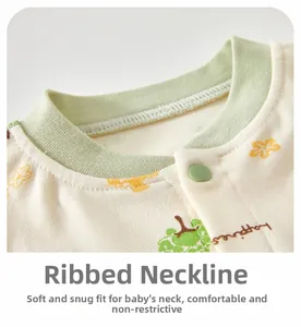 Detailed view of baby cotton ribbed neckline with green snaps and happiness print