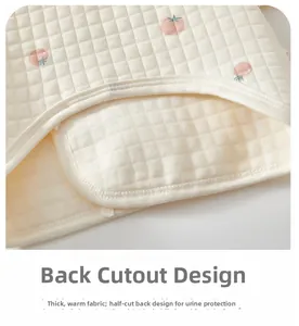Detail of quilted cotton baby top with peach print and U-shaped back for warmth