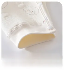 Detail showing ribbed cuff and waffle texture with cute puppy print on baby romper