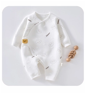 Detail of baby waffle knit romper featuring cartoon dog print and side snap closure