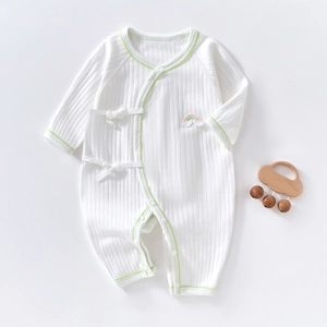 Detail of baby cotton rib romper with green trim, rainbow embroidery and side ties