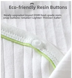 Detail of eco-friendly food-grade POM resin buttons on white ribbed cotton baby bodysuit