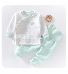 Detail of baby thermal long sleeve set featuring quilted honeycomb texture and side tags