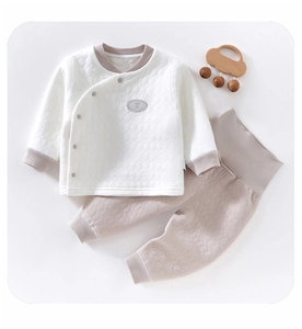 Detail view of quilted baby thermal set with side-snap top and high-waist pants