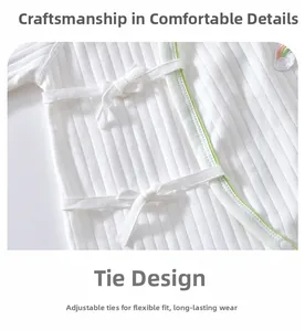 Detail of baby romper with ribbed cotton fabric, rainbow embroidery and side tie closure