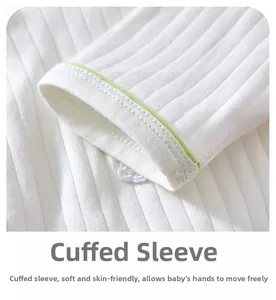 Detailed close-up of soft ribbed cotton baby romper sleeve with light green hem design