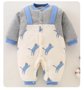 Dettaglio tutina neonato con stampe di gatti blu e morbida trama in cotone a nido d'ape