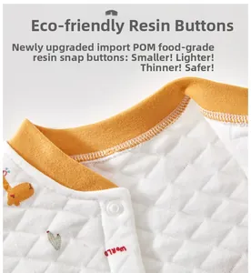 Close-up of baby quilted vest with yellow ribbed neckline and safe POM resin buttons